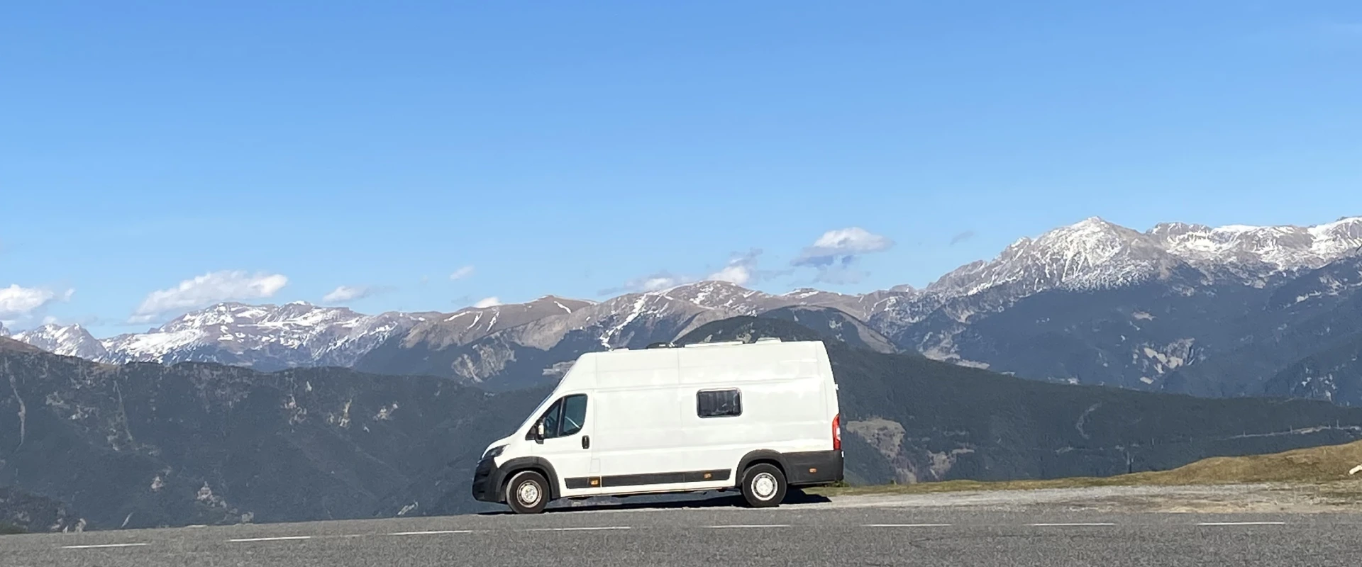 Imagen del banner principal de la pagina de venta de stvans, en ella se puede ver una furgoneta camperizada y sobre una montaña con montañas nevadas de fondo